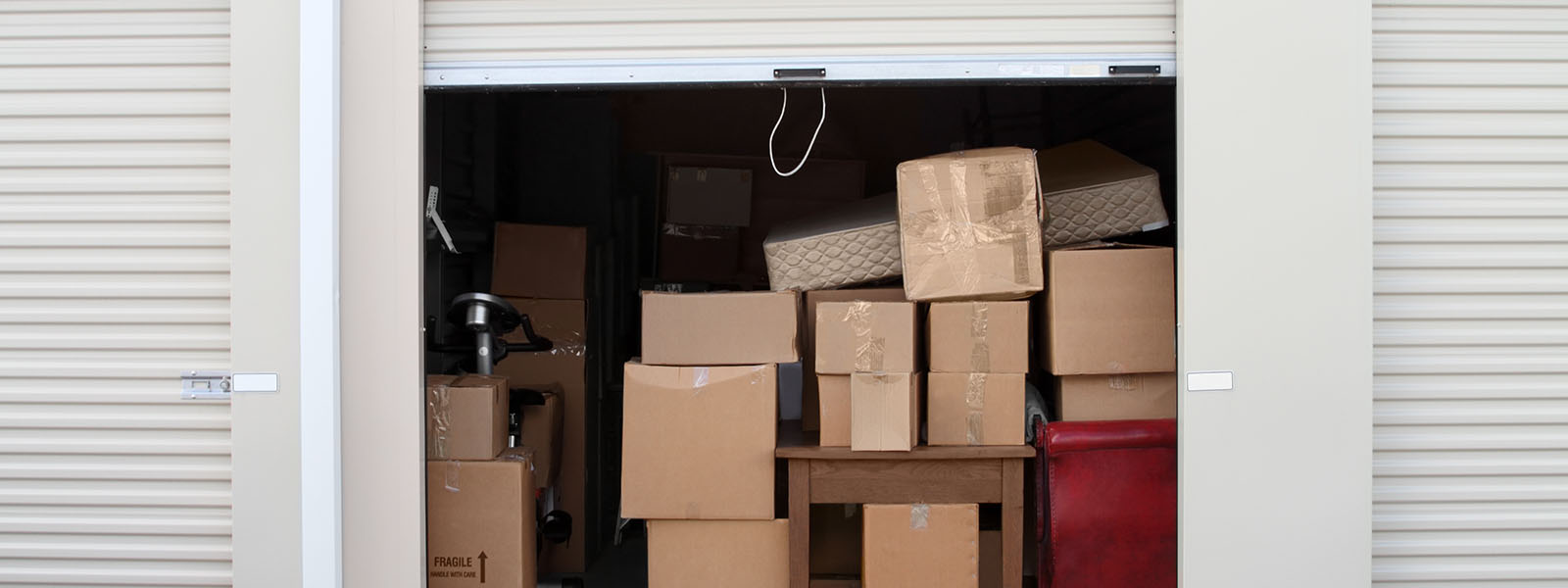 A storage unit full of cardboard boxes and household items | Simon Long Removals Gloucester